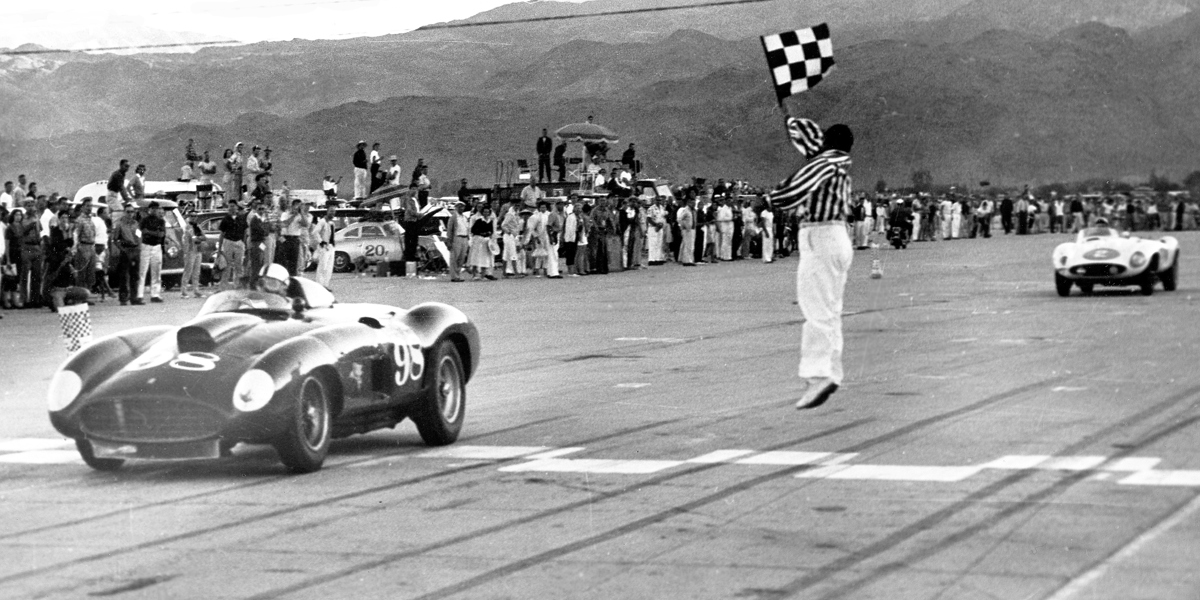 Al Torres waves the checkered flag as Shelby in the Ferrari 410 Sport bests Phil Hill in the Ferrari Monza at Palm Springs